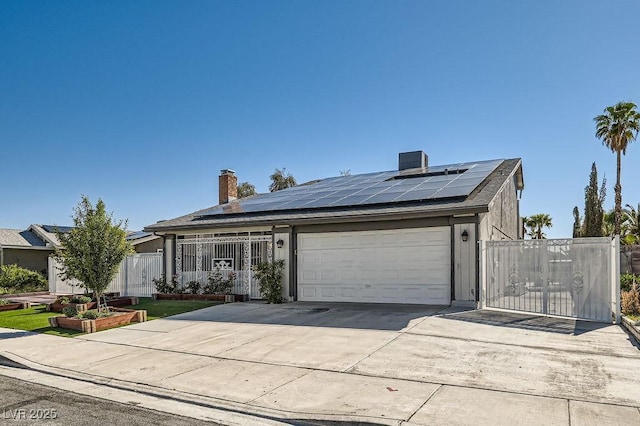 4302 Newhaven Dr, Las Vegas, NV 89147 - view of front of property featuring a chimney, solar panels, concrete driveway, a garage, and fence