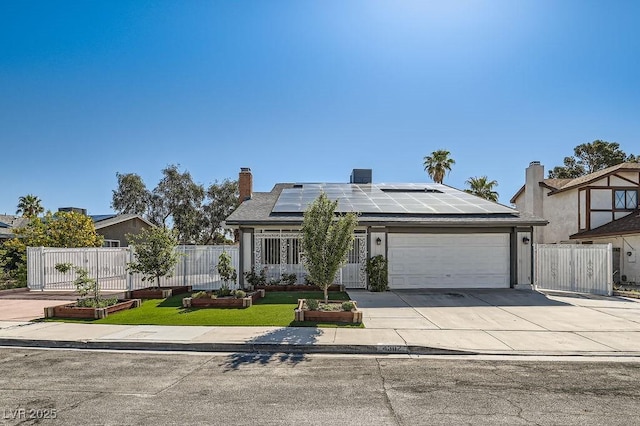 4302 Newhaven Dr, Las Vegas, NV 89147 - view of front facade featuring an attached garage, roof mounted solar panels, driveway, fence, and a chimney