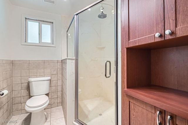 4302 Newhaven Dr, Las Vegas, NV 89147 - full bathroom featuring tile walls, toilet, a stall shower, tile patterned floors, and wainscoting