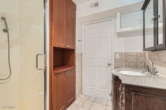 4302 Newhaven Dr, Las Vegas, NV 89147 - bathroom with tile patterned floors, a shower stall, vanity, and tile walls