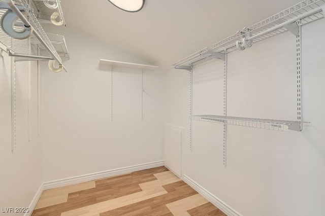 4302 Newhaven Dr, Las Vegas, NV 89147 - walk in closet with light wood-type flooring and vaulted ceiling