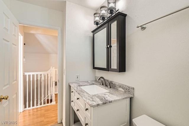 4302 Newhaven Dr, Las Vegas, NV 89147 - bathroom featuring vanity, wood finished floors, and toilet