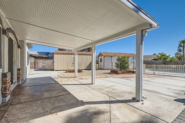 4302 Newhaven Dr, Las Vegas, NV 89147 - view of patio / terrace with a storage shed, an outbuilding, and fence