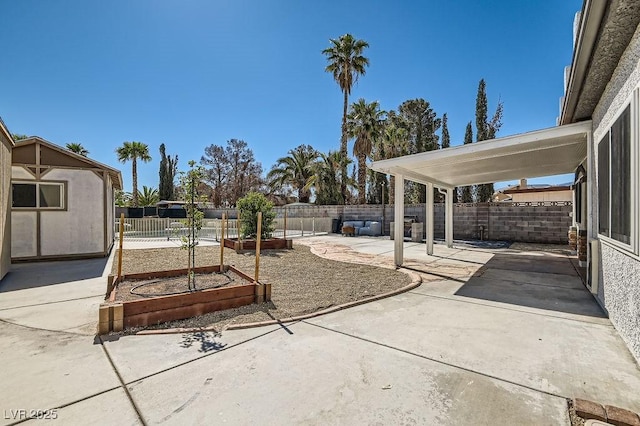 4302 Newhaven Dr, Las Vegas, NV 89147 - view of patio / terrace featuring a vegetable garden and a fenced backyard