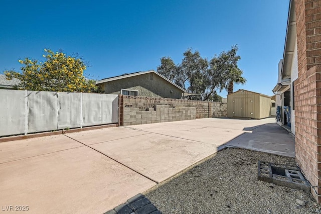 4302 Newhaven Dr, Las Vegas, NV 89147 - view of patio / terrace with a shed, an outdoor structure, and a fenced backyard