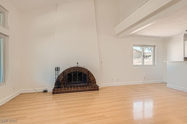 4302 Newhaven Dr, Las Vegas, NV 89147 - unfurnished living room with light wood-type flooring, a brick fireplace, and baseboards