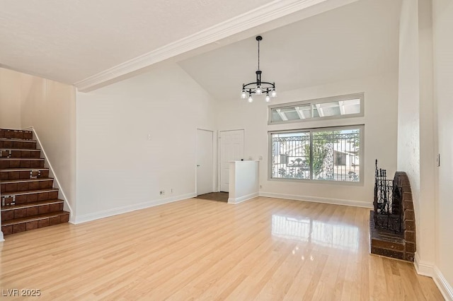 4302 Newhaven Dr, Las Vegas, NV 89147 - unfurnished living room featuring stairs, a chandelier, wood finished floors, baseboards, and high vaulted ceiling