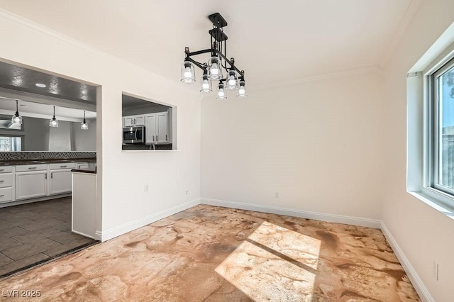 4302 Newhaven Dr, Las Vegas, NV 89147 - unfurnished dining area with ornamental molding, plenty of natural light, and baseboards