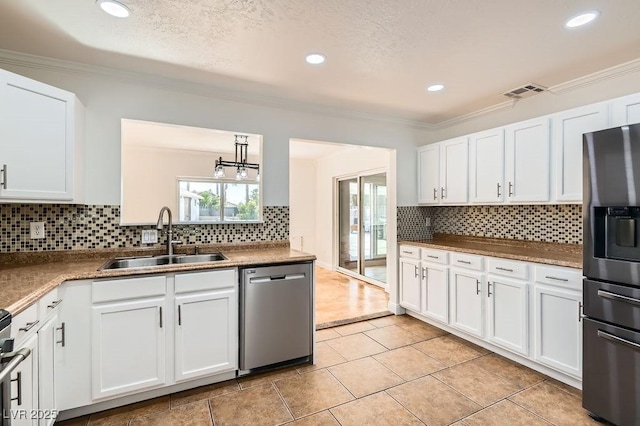 4302 Newhaven Dr, Las Vegas, NV 89147 - kitchen featuring stainless steel appliances, a sink, crown molding, white cabinets, and recessed lighting