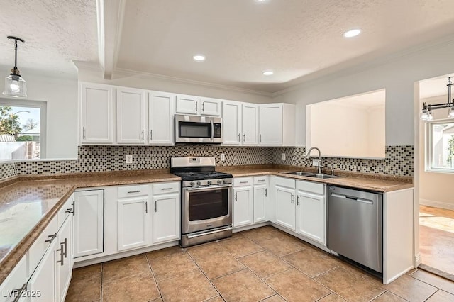 4302 Newhaven Dr, Las Vegas, NV 89147 - kitchen with appliances with stainless steel finishes, a sink, crown molding, plenty of natural light, and a textured ceiling