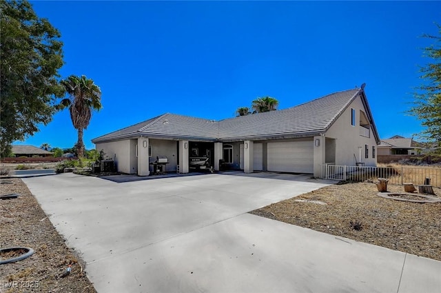 1420 Logandale Dr, Logandale, NV 89021 - single story home with stucco siding, driveway, fence, a garage, and a tile roof