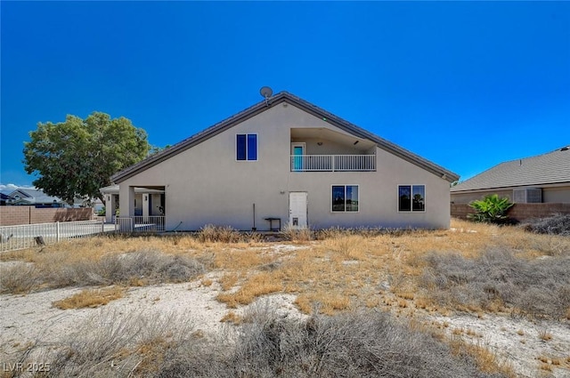 1420 Logandale Dr, Logandale, NV 89021 - rear view of house featuring stucco siding, fence, and a balcony