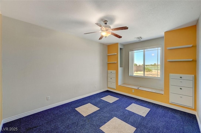 1420 Logandale Dr, Logandale, NV 89021 - empty room featuring a ceiling fan, dark colored carpet, baseboards, and a textured ceiling