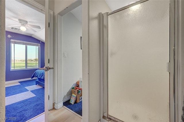 1420 Logandale Dr, Logandale, NV 89021 - full bath with lofted ceiling, a stall shower, baseboards, a ceiling fan, and wood finished floors