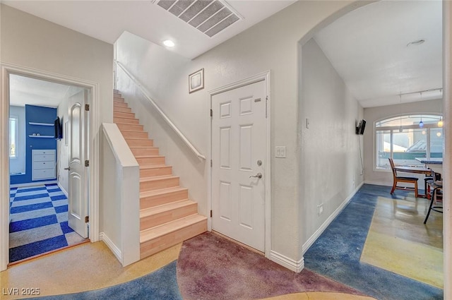 1420 Logandale Dr, Logandale, NV 89021 - entryway with baseboards, arched walkways, plenty of natural light, and stairs