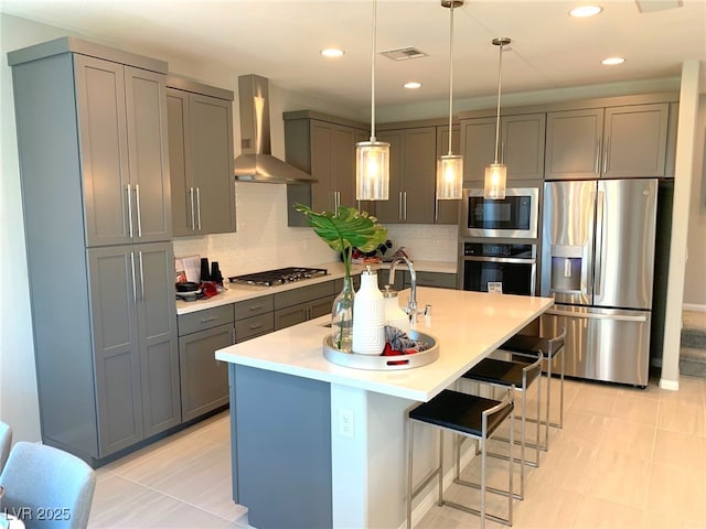 6511 Dove Point Pl, Las Vegas, NV 89130 - kitchen featuring stainless steel appliances, wall chimney range hood, gray cabinetry, a sink, and light countertops