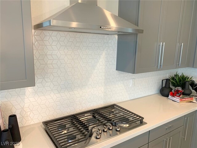 6511 Dove Point Pl, Las Vegas, NV 89130 - kitchen featuring ventilation hood, gray cabinets, light countertops, stainless steel gas cooktop, and backsplash