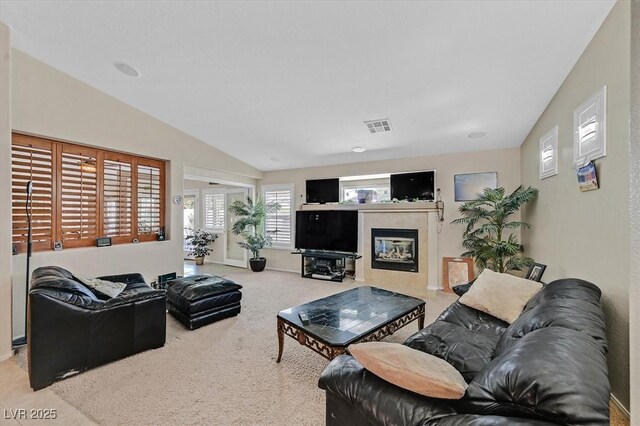 8208 Flowing Rapids Ct, Las Vegas, NV 89131 - living area with carpet flooring, a glass covered fireplace, and vaulted ceiling