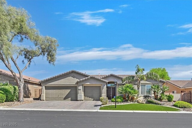 8208 Flowing Rapids Ct, Las Vegas, NV 89131 - ranch-style home with a garage, decorative driveway, stucco siding, a tile roof, and fence