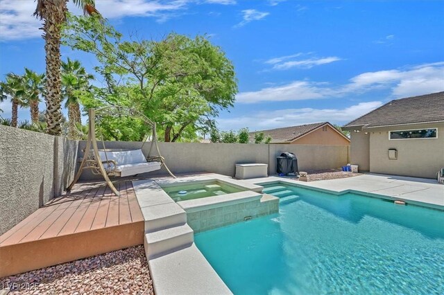 8208 Flowing Rapids Ct, Las Vegas, NV 89131 - view of swimming pool featuring a fenced backyard, a deck, and a pool with connected hot tub