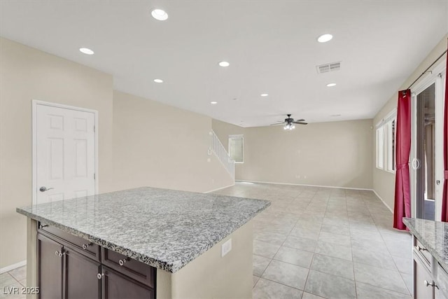 3638 Via Messina, Henderson, NV 89052 - kitchen with ceiling fan, recessed lighting, light stone countertops, light tile patterned flooring, and baseboards
