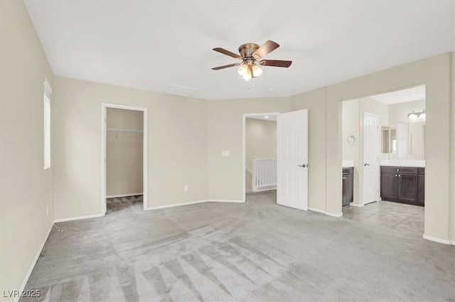 3638 Via Messina, Henderson, NV 89052 - unfurnished bedroom with light carpet, baseboards, a walk in closet, connected bathroom, and a closet