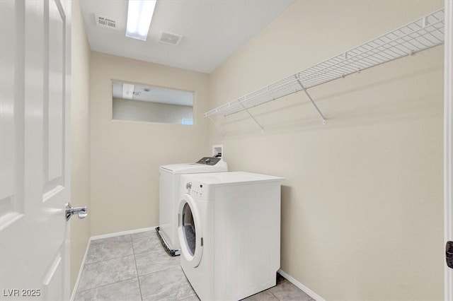 3638 Via Messina, Henderson, NV 89052 - laundry area with washer and clothes dryer, baseboards, and light tile patterned floors