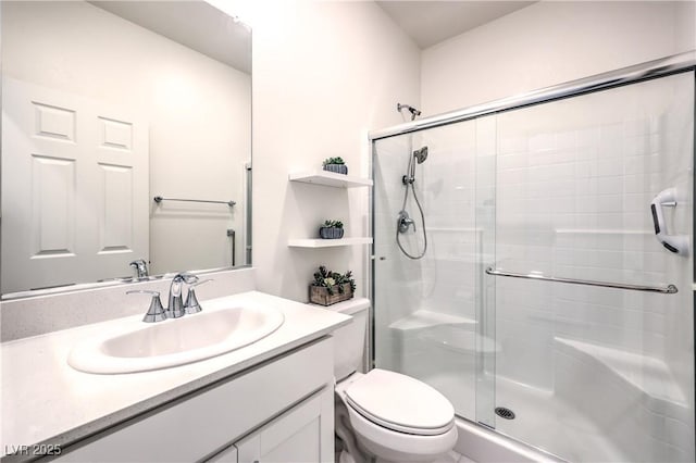full bath with a shower stall, toilet, and vanity