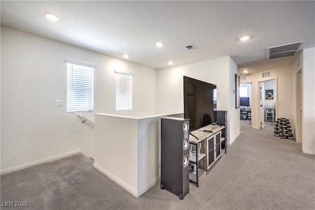 hallway with carpet, recessed lighting, and baseboards