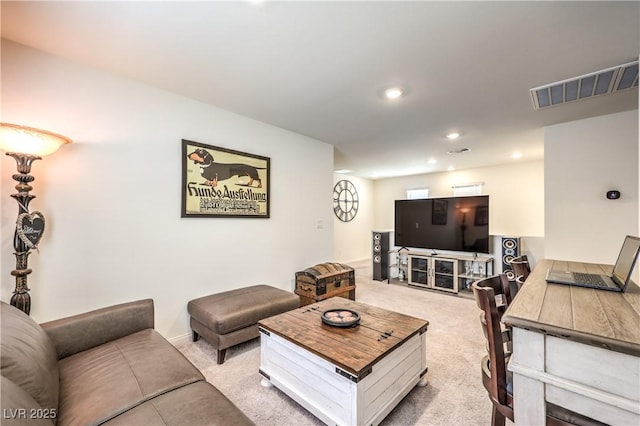 living area featuring light carpet and recessed lighting
