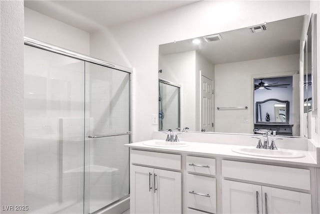 full bath with a shower stall and double vanity