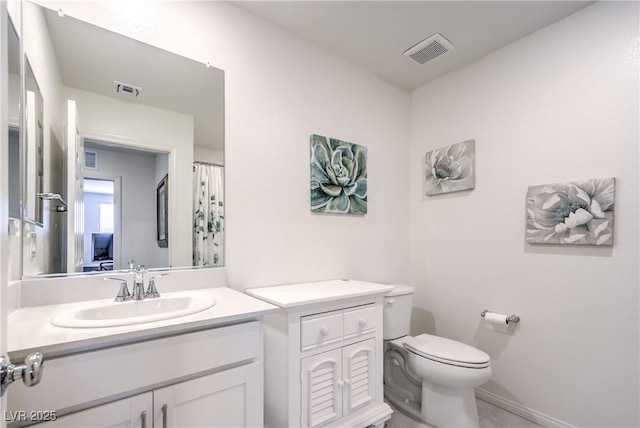full bath with toilet, vanity, and baseboards