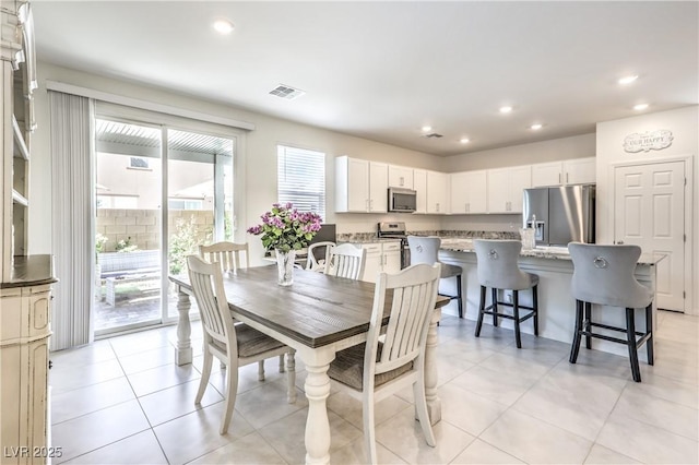 dining room featuring recessed lighting and light tile patterned floors