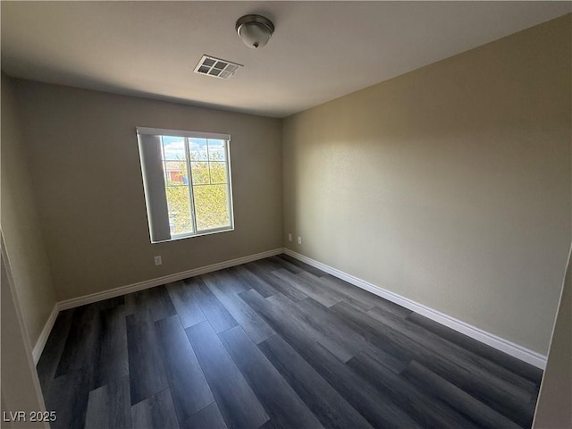 unfurnished room with dark wood-style floors and baseboards