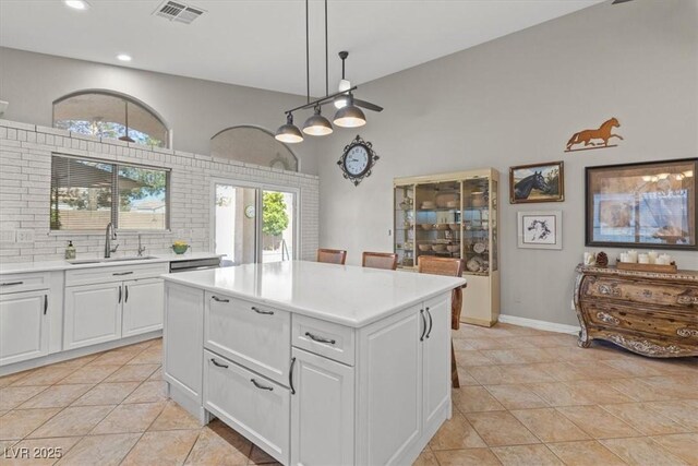5421 Tourmaline St, Las Vegas, NV 89130 - kitchen with a sink, white cabinets, light countertops, recessed lighting, and light tile patterned flooring