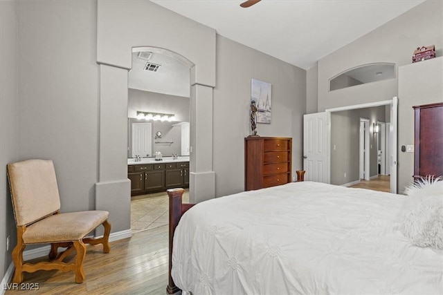 5421 Tourmaline St, Las Vegas, NV 89130 - bedroom featuring light wood-style floors, baseboards, ensuite bath, high vaulted ceiling, and a ceiling fan