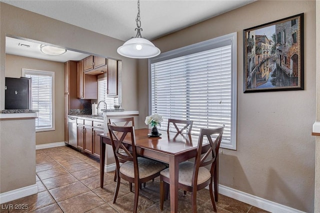 dining room with baseboards and tile patterned flooring