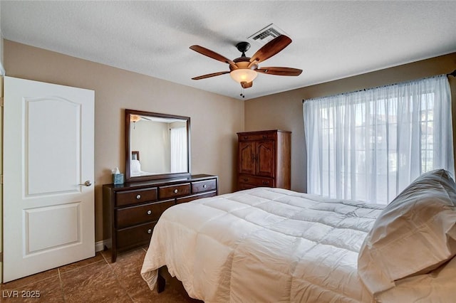 bedroom featuring tile patterned floors and a ceiling fan
