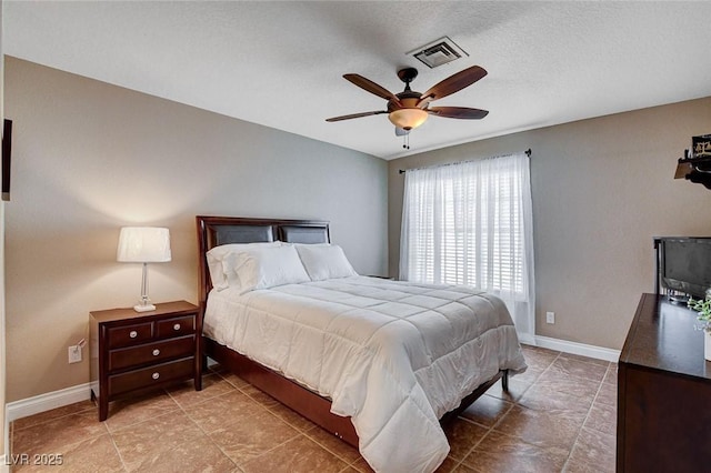 bedroom featuring baseboards, tile patterned floors, and a ceiling fan