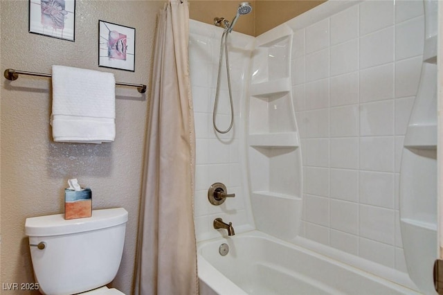 bathroom with a textured wall, shower / bath combination with curtain, and toilet