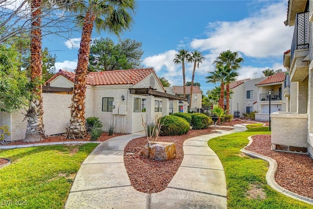 view of front of home featuring a tiled roof, a residential view, and stucco siding