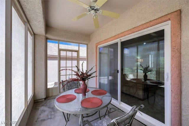 sunroom / solarium featuring concrete floors