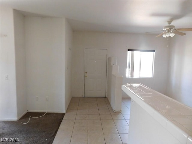 hall featuring light tile patterned flooring
