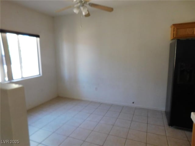 unfurnished room featuring a ceiling fan and light tile patterned flooring