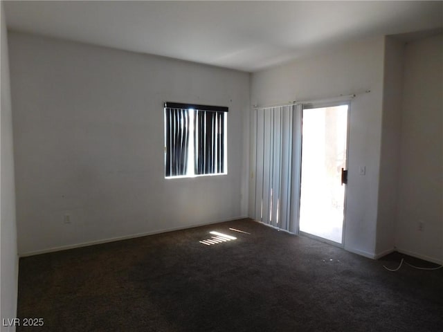 empty room with carpet and baseboards