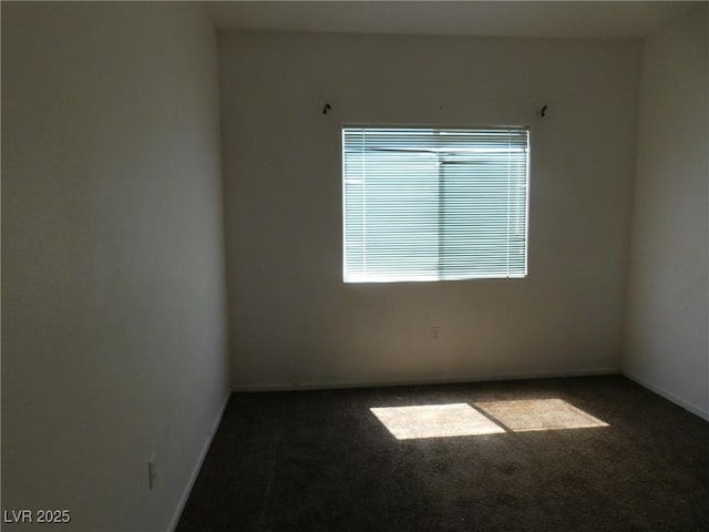 empty room with carpet and baseboards