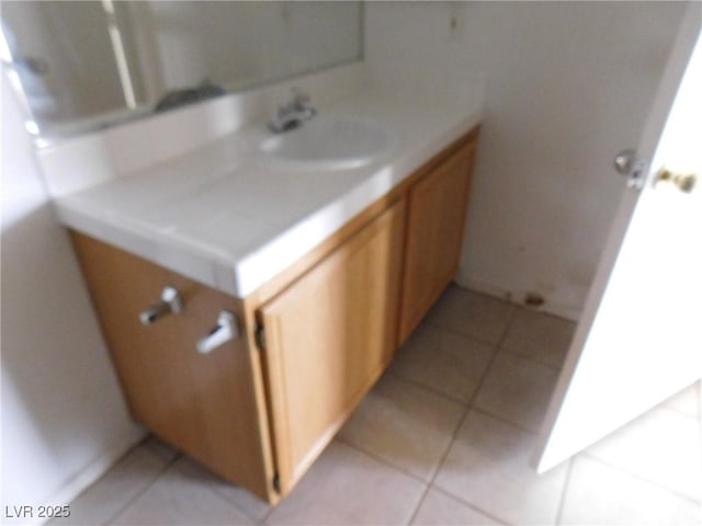 bathroom featuring tile patterned flooring and vanity