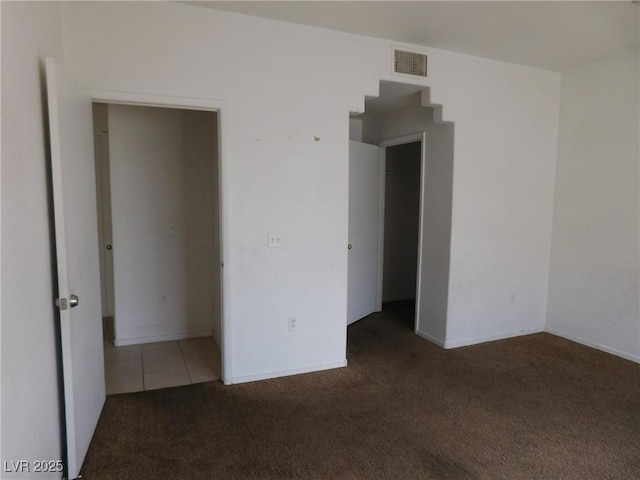 carpeted empty room with baseboards