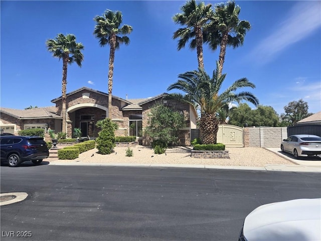 8078 Leather Harness St, Las Vegas, NV 89131 - view of front facade featuring a gate and stone siding