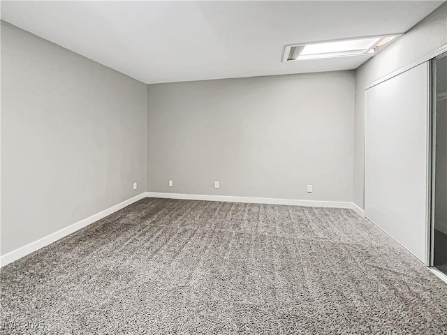 carpeted spare room with baseboards